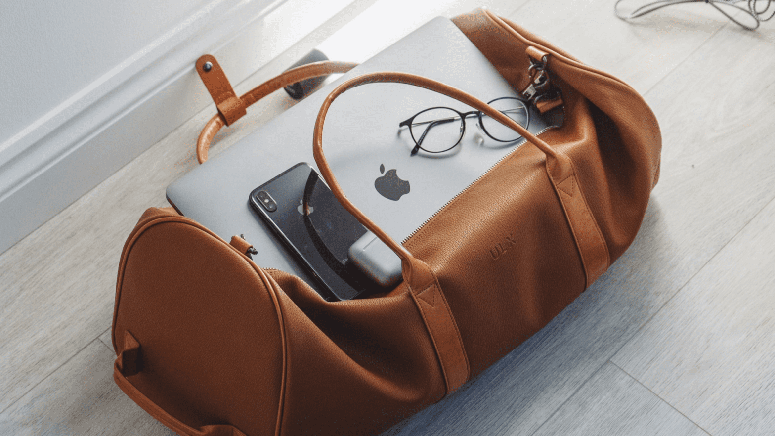 Duffel bag with phone and laptop